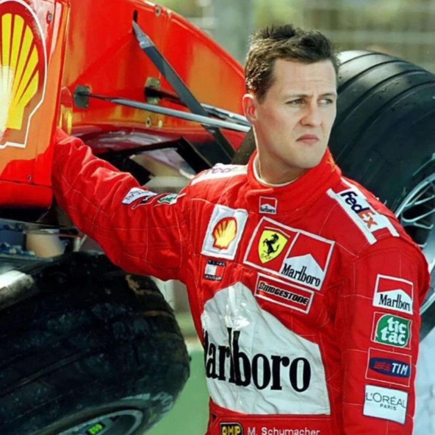 Michael Schumacher 2002 Ferrari F1 Racing Suit in red featuring iconic Ferrari racing graphics and authentic sponsor detailing