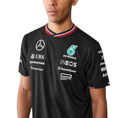 2024 Mercedes-AMG Petronas F1 Pilot T-Shirt in black featuring Mercedes-AMG, Petronas and team sponsor logos with a red and black striped crew neck