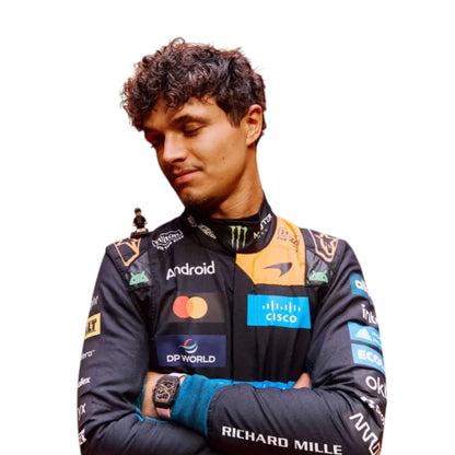 Lando Norris 2026 McLaren 1000th Monaco GP F1 race suit featuring a black, papaya orange and blue colourway with special edition McLaren detailing