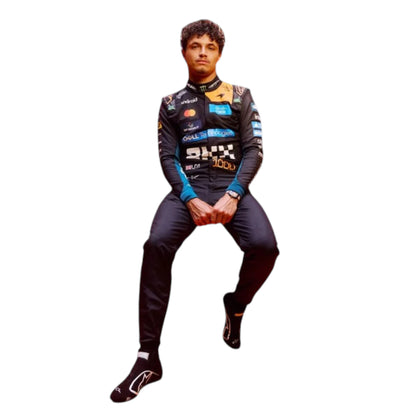 Lando Norris 2026 McLaren 1000th Monaco GP F1 race suit featuring a black, papaya orange and blue colourway with special edition McLaren detailing