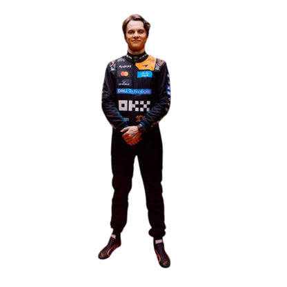 Oscar Piastri 2026 McLaren 1000th Monaco GP F1 race suit featuring a black, papaya orange and blue colourway with special edition McLaren detailing