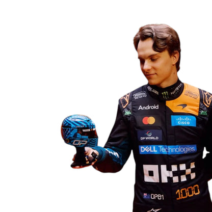 Oscar Piastri 2026 McLaren 1000th Monaco GP F1 race suit featuring a black, papaya orange and blue colourway with special edition McLaren detailing