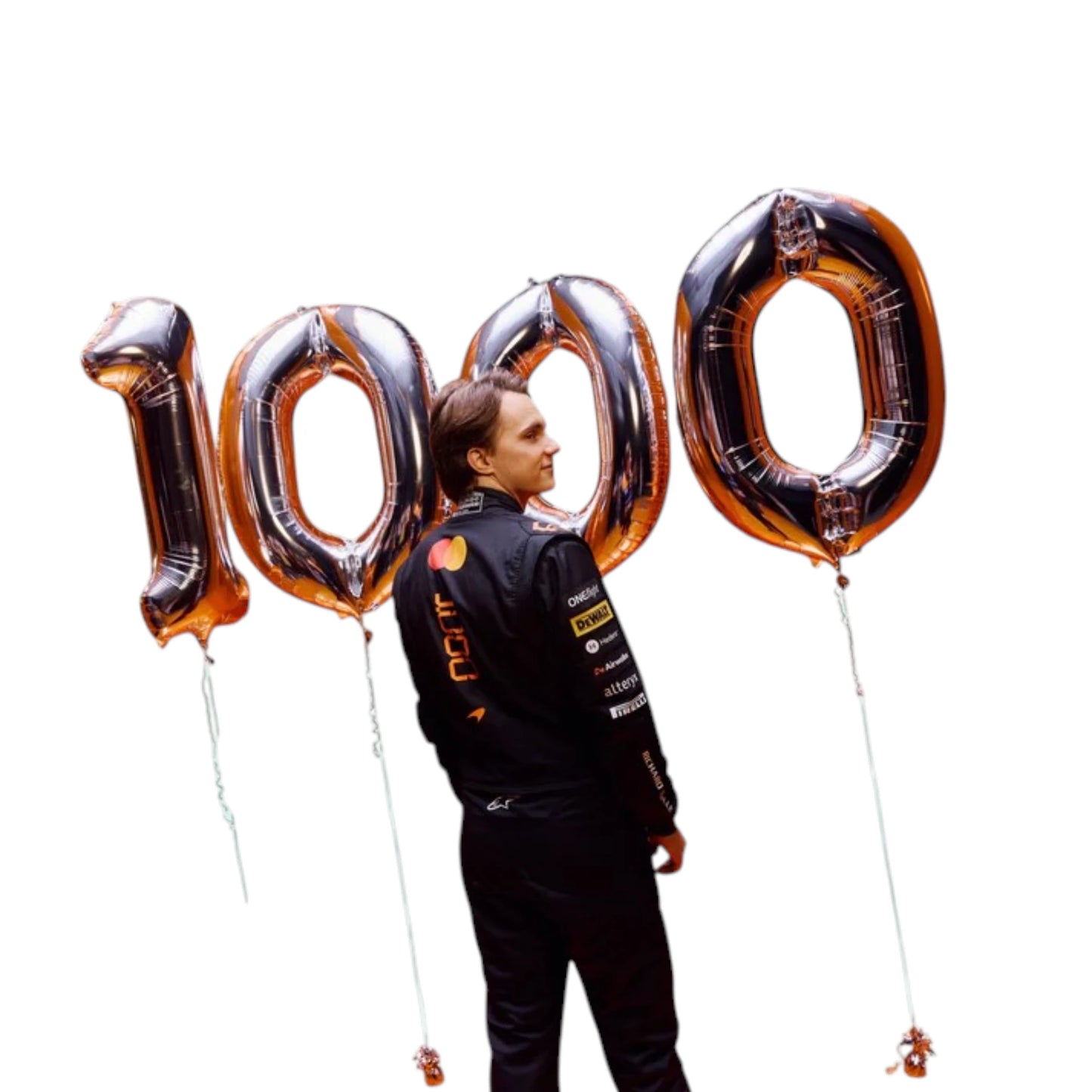 Oscar Piastri 2026 McLaren 1000th Monaco GP F1 race suit featuring a black, papaya orange and blue colourway with special edition McLaren detailing